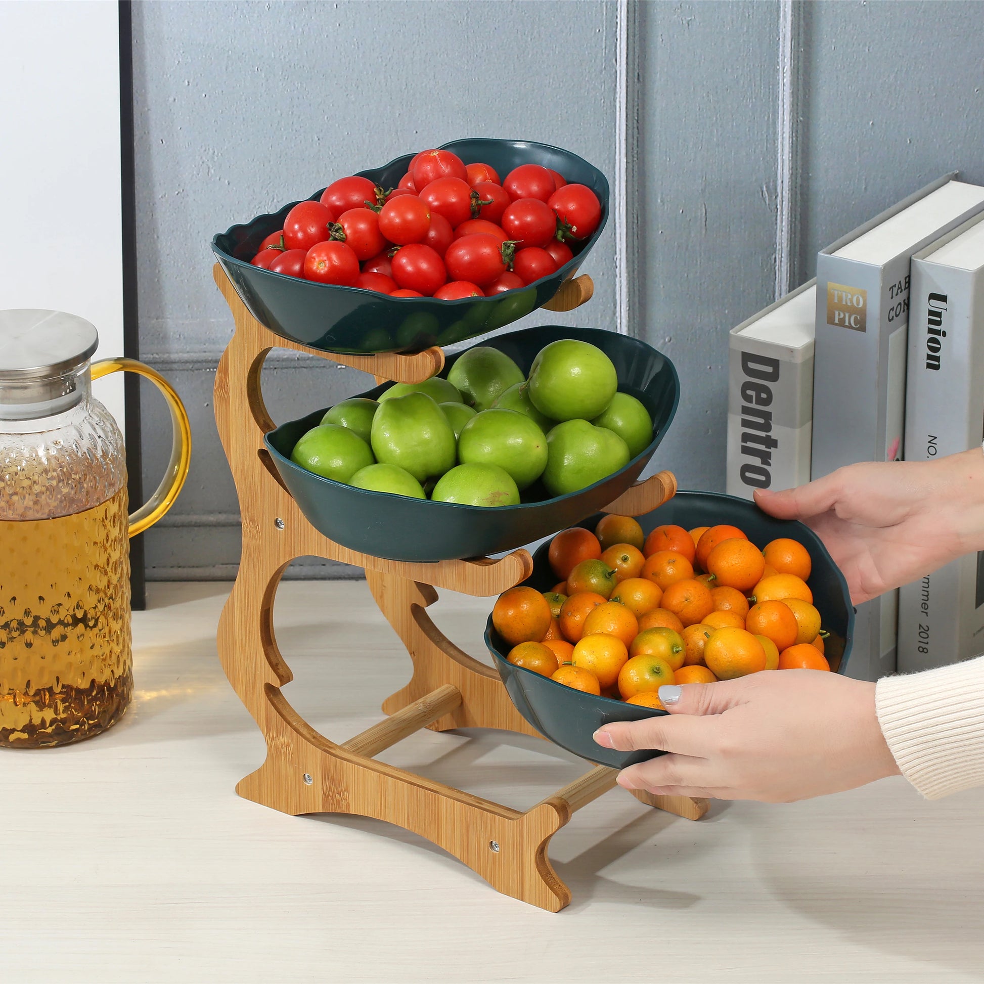 Nutshell Multi-Tier Serving Stand fruit bowl with three tiers holding tomatoes, green apples, and oranges