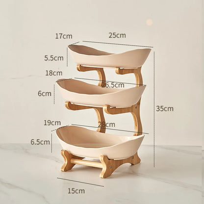 Nutshell multi-tier serving stand with three beige fruit bowls and wooden frame dimensions shown