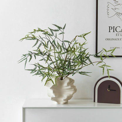 Nordic art coral vase by Nutshell in white with green fern branches on white cabinet