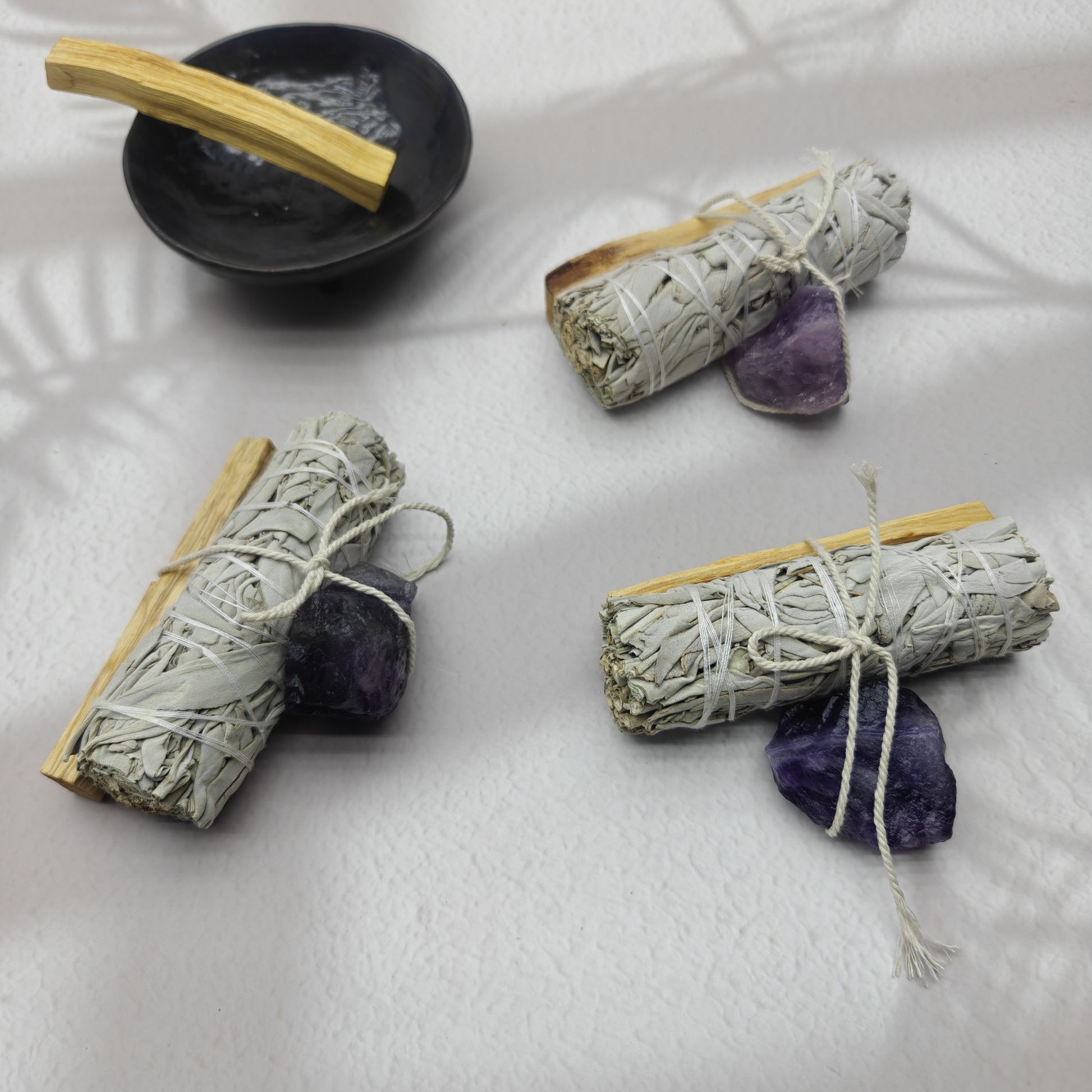 Palo Santo White Sage Crystal set featuring bundles of sage and amethyst crystals with a black bowl