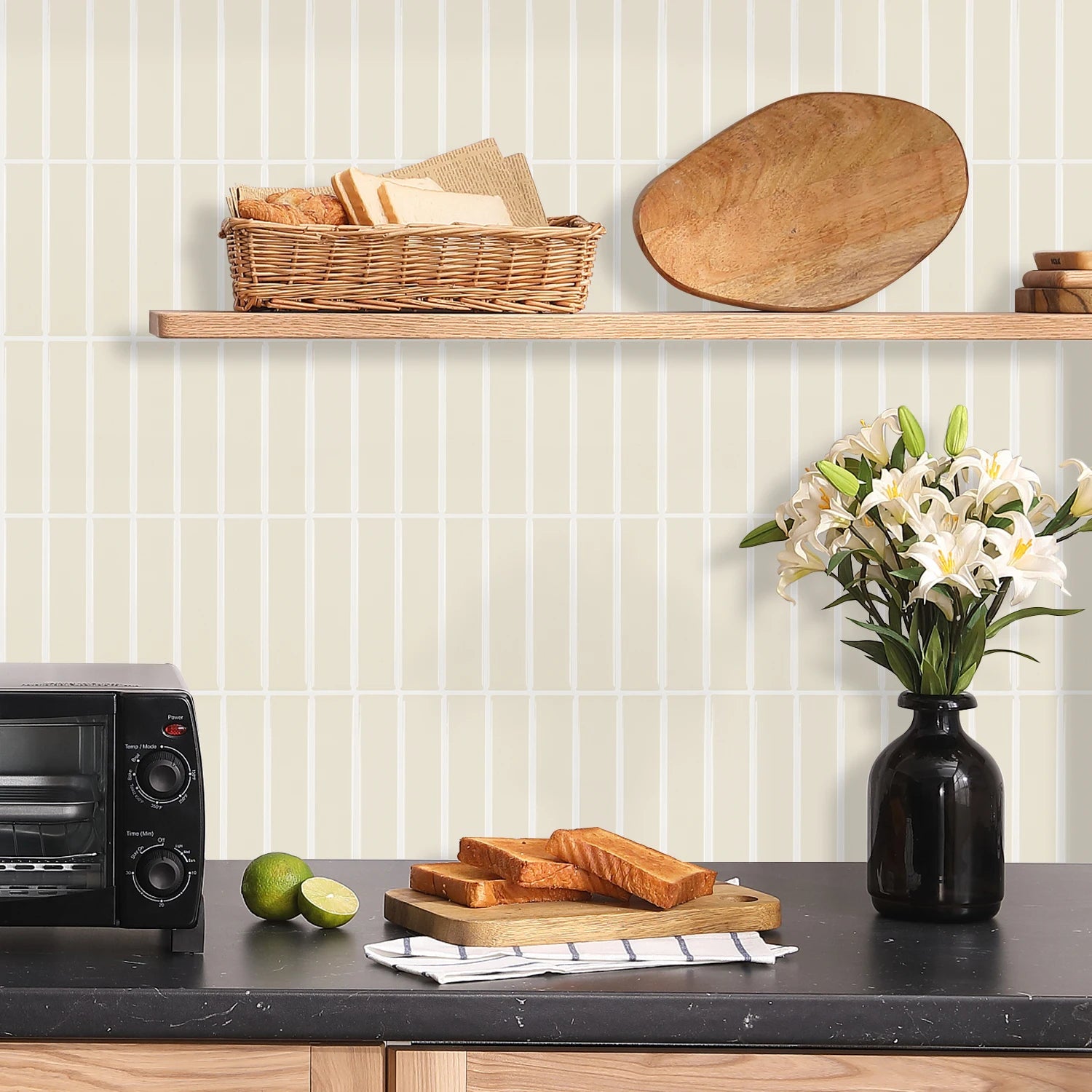 Kitchen countertop with black toaster oven wooden cutting board toast lime vase of white lilies and beige DIY Backsplash Tiles