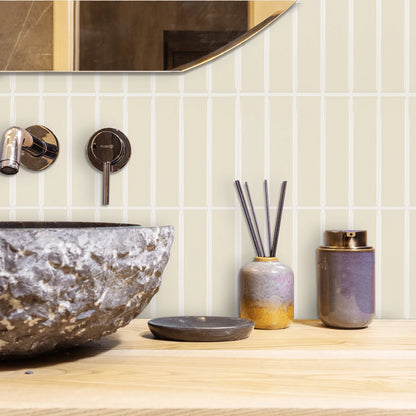 Nutshell DIY Backsplash Tiles in cream vertical layout behind stone vessel sink and decorative jars