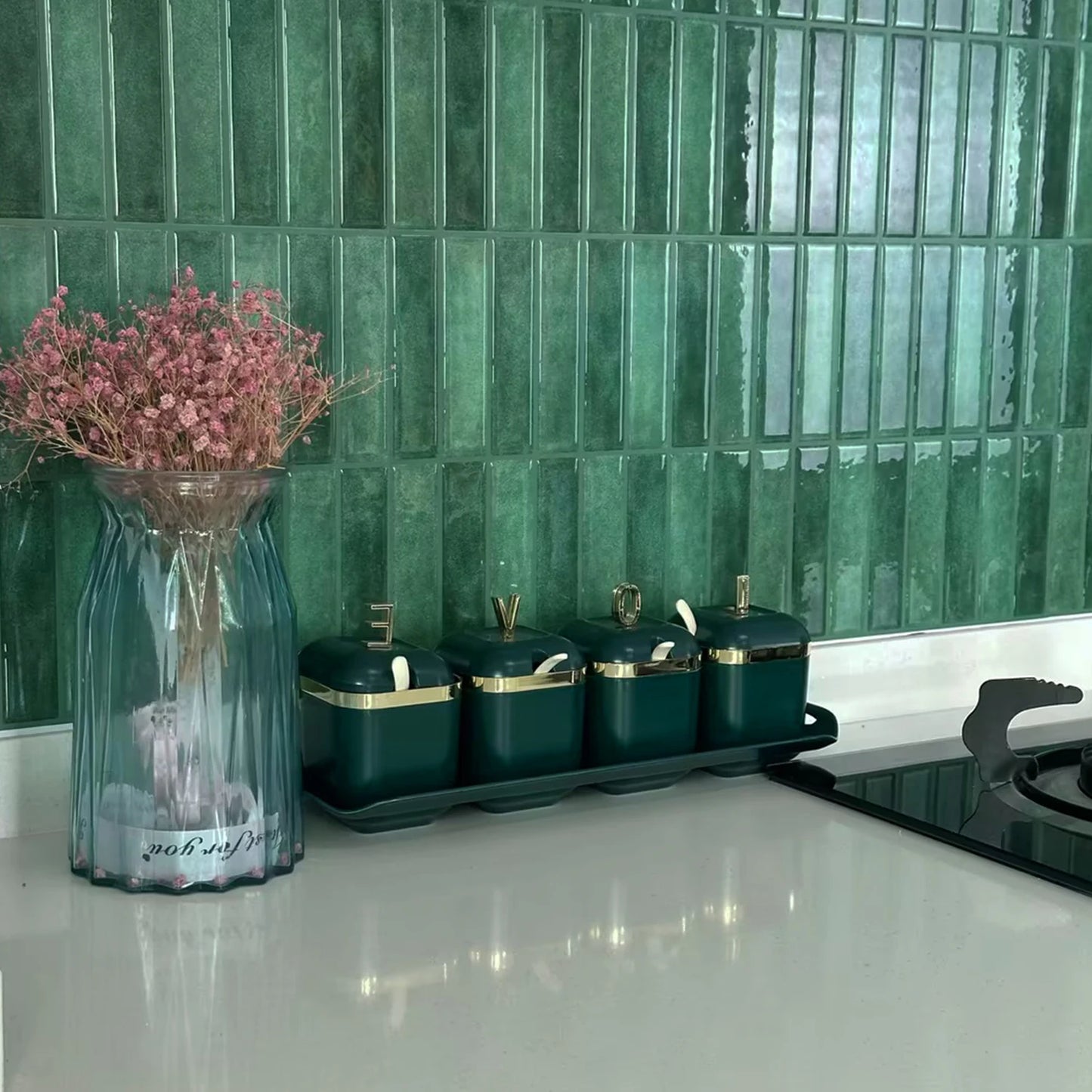 Nutshell DIY Backsplash Tiles in glossy green vertical subway pattern behind kitchen counter with canisters