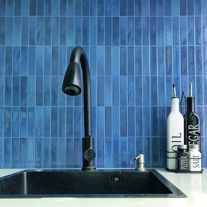 DIY Backsplash Tiles Nutshell blue glossy vertical tiles behind black kitchen faucet and sink with oil bottles