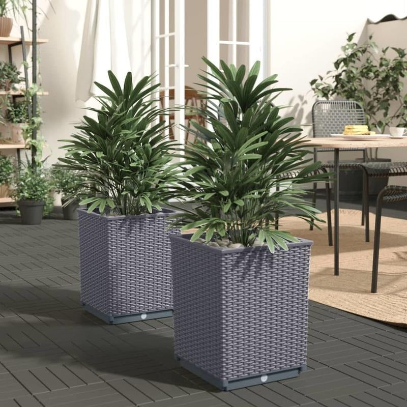 Large blue grey planters for indoor use showcasing potted plants in a stylish setting