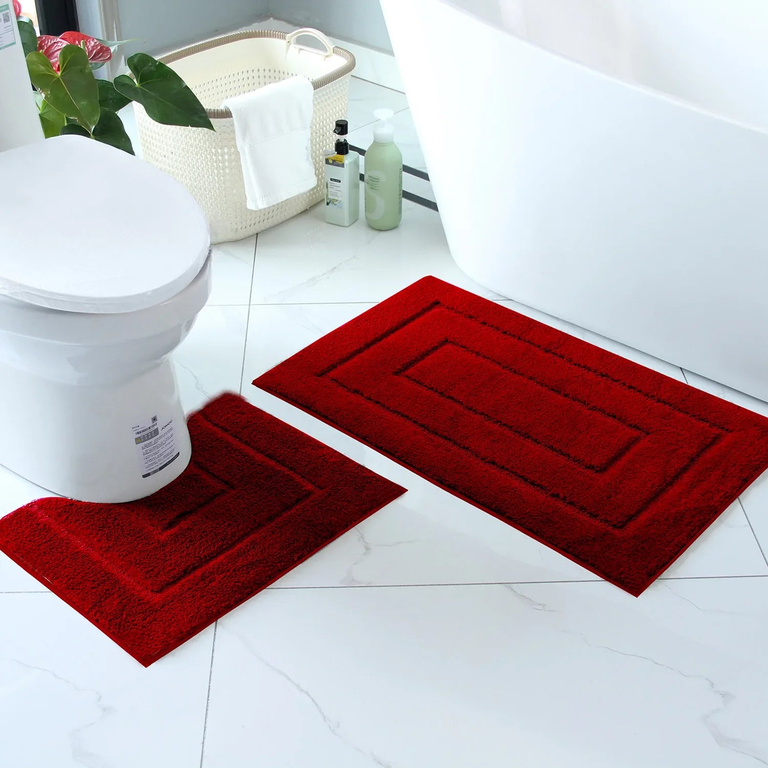 Red plush bathroom floor mat set including a large mat and a smaller contour mat for comfort