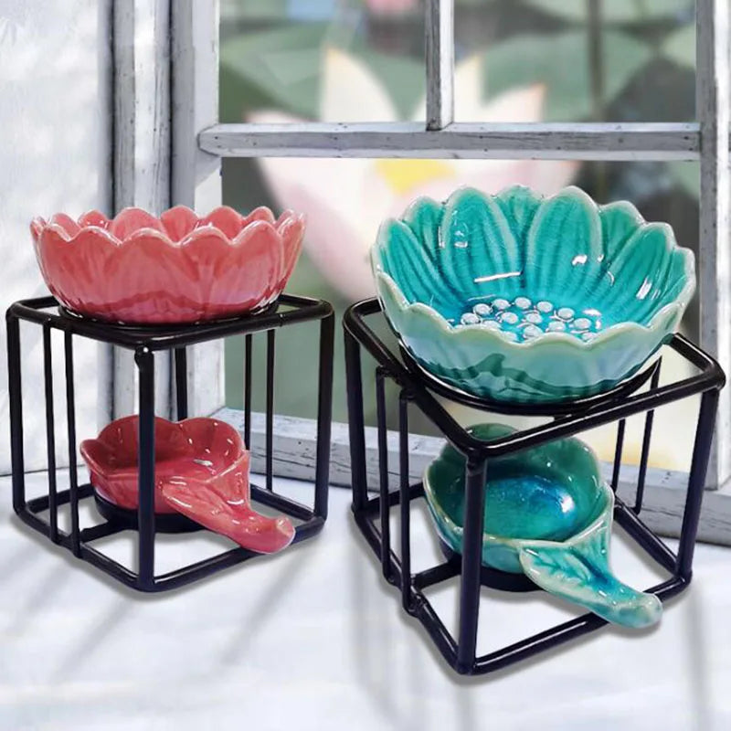 Porcelain lotus essential oil burner by Nutshell in pink and teal with black metal stands