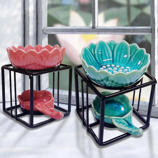Porcelain lotus essential oil burner by Nutshell in pink and teal with black metal stands