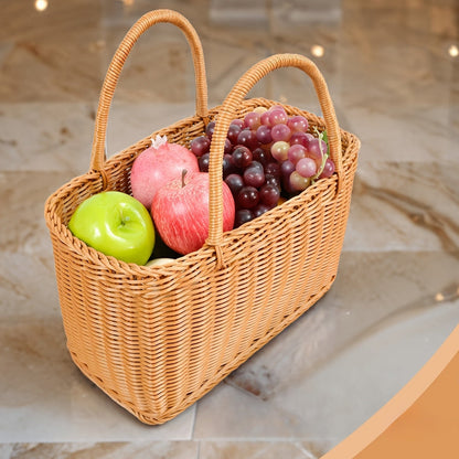 Nutshell rattan picnic basket filled with fresh apples and grapes for outdoor dining