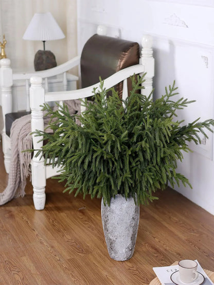 Nutshell real touch faux pine branches arranged in a decorative stone vase in a cozy living room