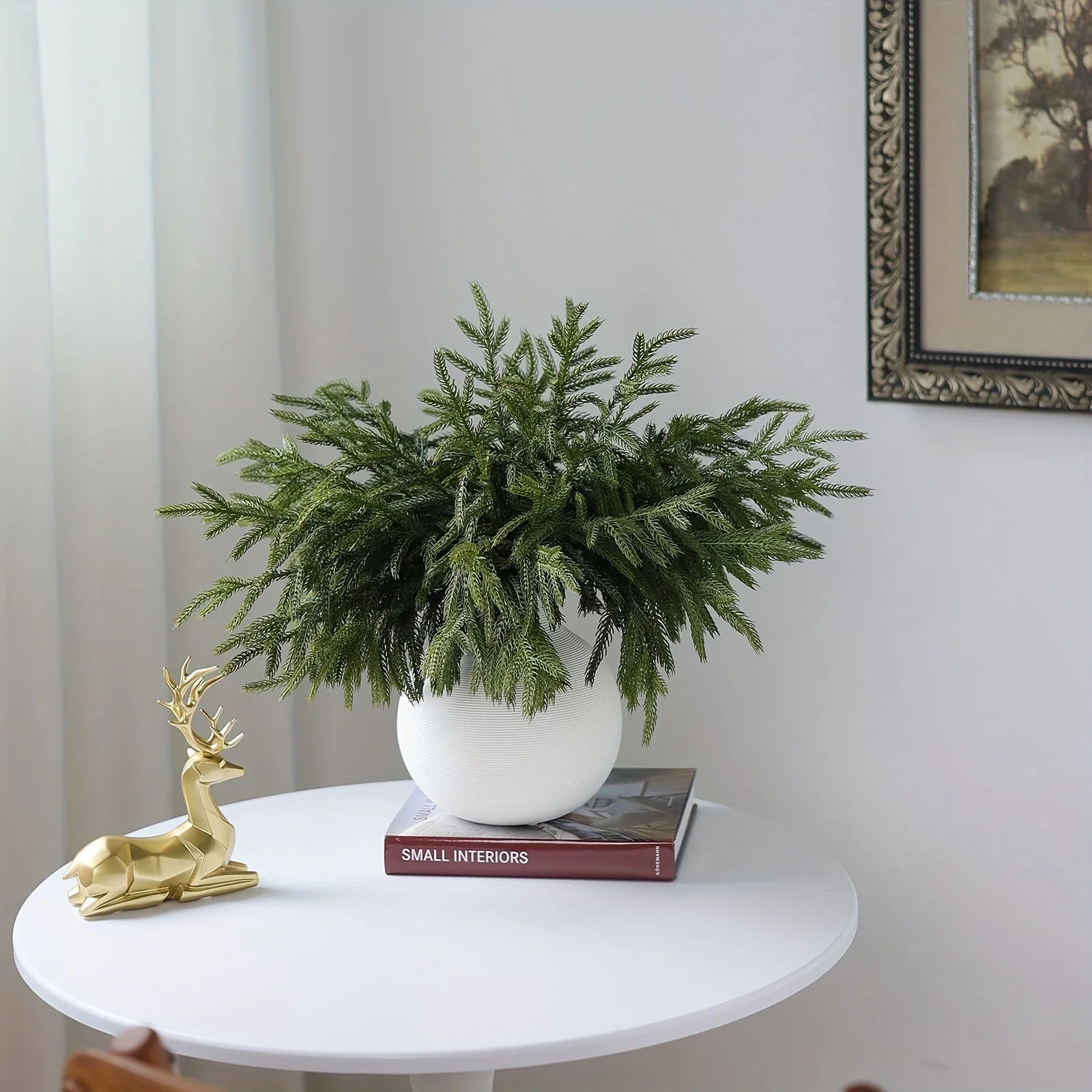 Real touch faux pine branches arranged in a white pot for festive home decor