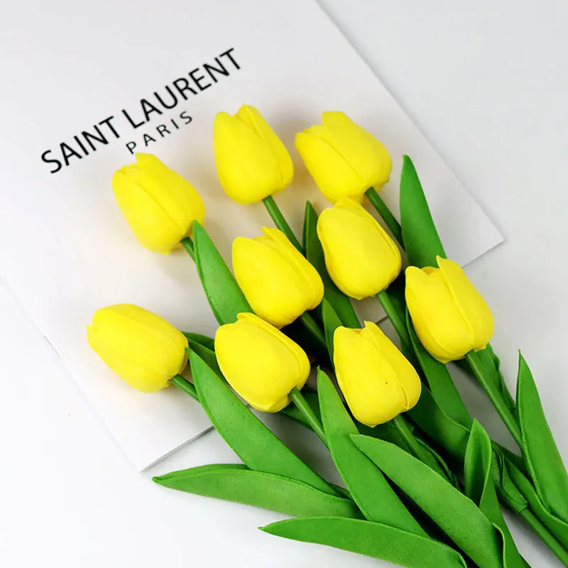 Realistic artificial tulip bouquet in bright yellow with green leaves for home decor