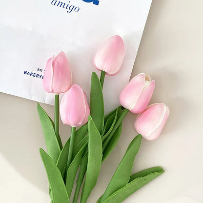 Realistic artificial tulip bouquet in pink with green leaves for home decor
