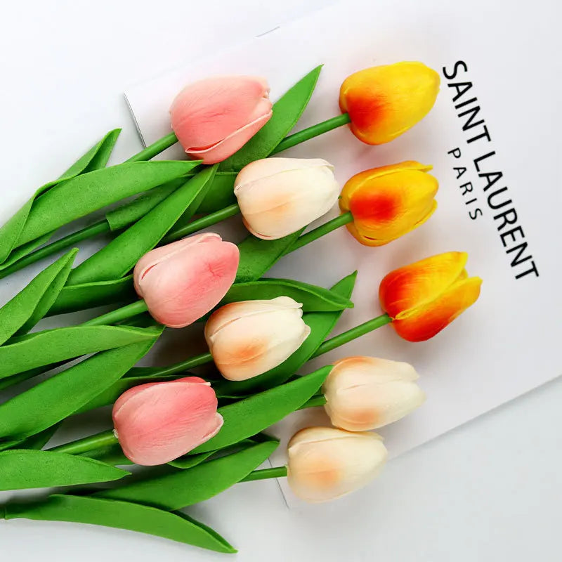Realistic artificial tulip bouquet in pink, yellow, and white colors with vibrant green leaves