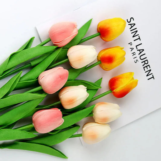 Realistic artificial tulip bouquet in pink, yellow, and white colors with vibrant green leaves
