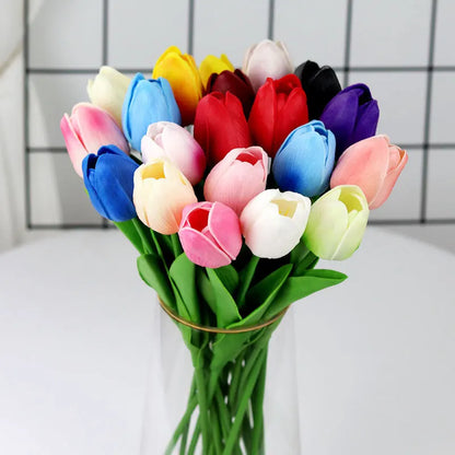 Colorful realistic artificial tulip bouquet in a glass vase for home decoration