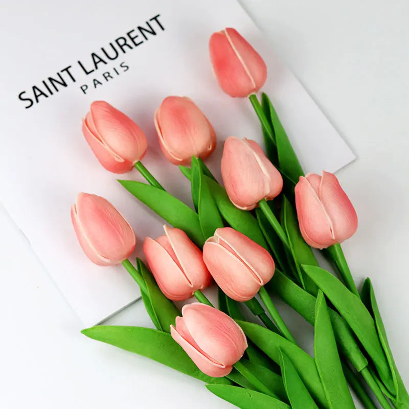 Realistic artificial tulip bouquet in soft pink with green leaves for home decor