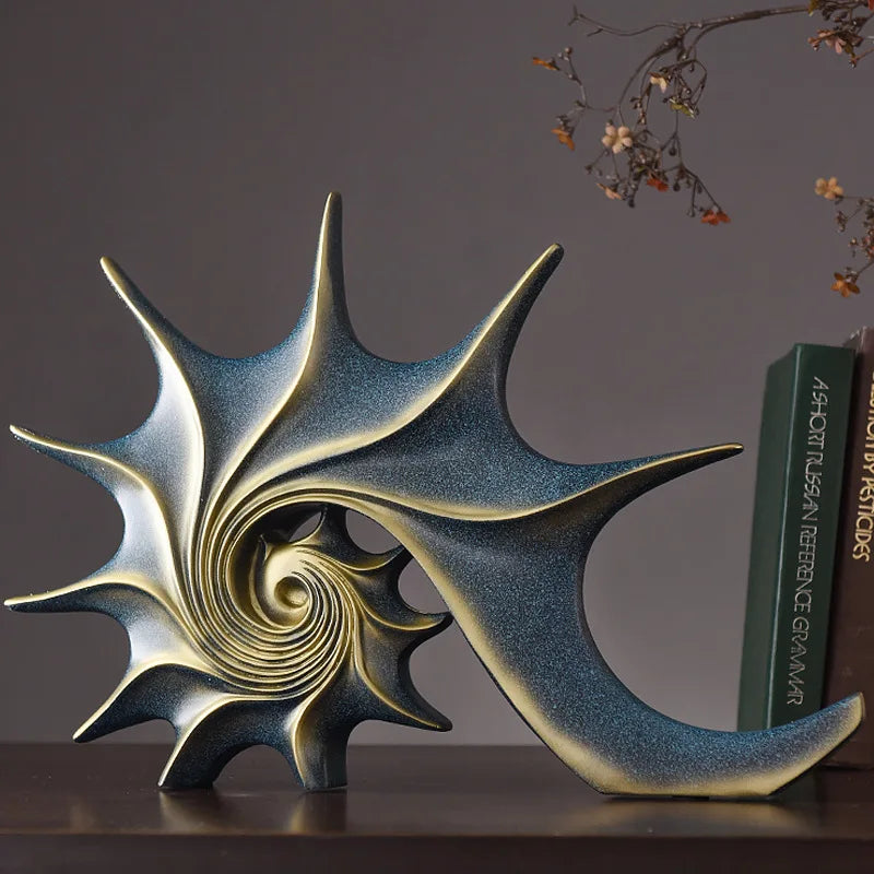 Nutshell resin conch Nordic statue decor with spiral design in blue and gold colors on a shelf