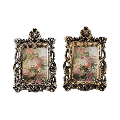 Set of two retro ornate photo frames in silver and gold featuring floral artwork