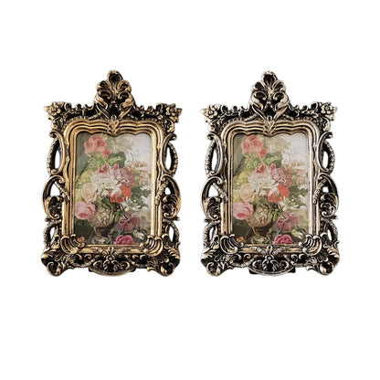 Set of two retro ornate photo frames in gold and silver with floral artwork display
