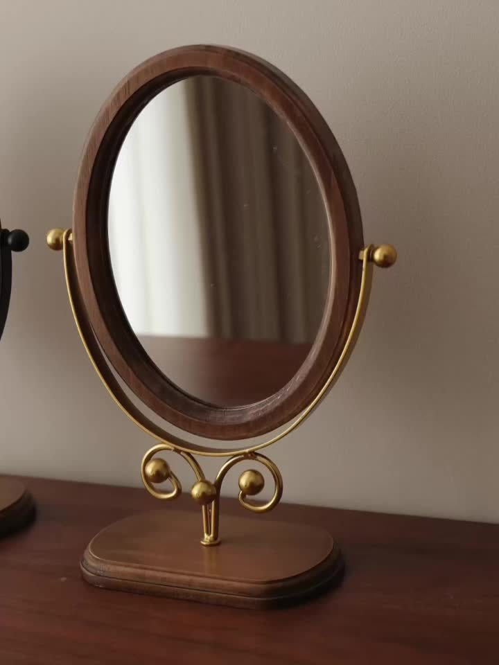 Elegant rotating iron frame mirror with a stylish wooden base for home decor