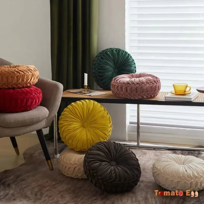 Nutshell round pumpkin pillow collection in various colors displayed on chair and floor for cozy home decor