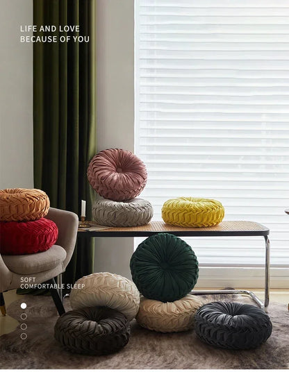 Nutshell round pumpkin pillow collection in various colors arranged in a cozy living room setting