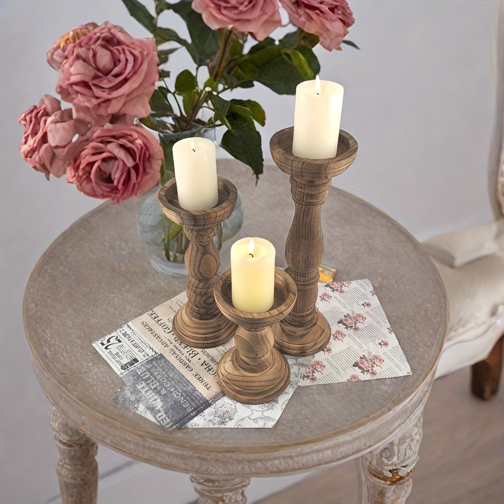 Rustic farmhouse wooden candle holders on a table with pink roses and vintage decor