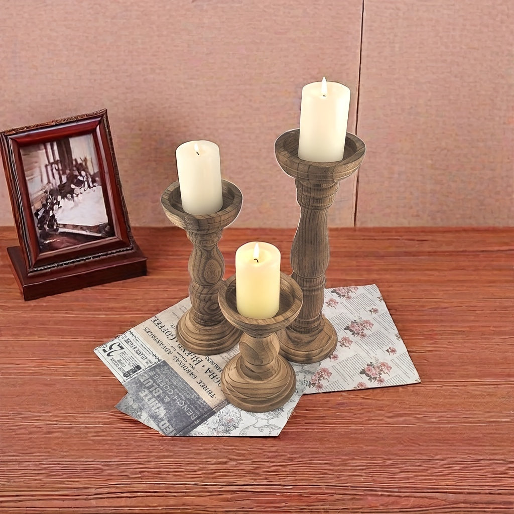 Set of rustic farmhouse wooden candle holders on a wooden table with candles for a cozy atmosphere