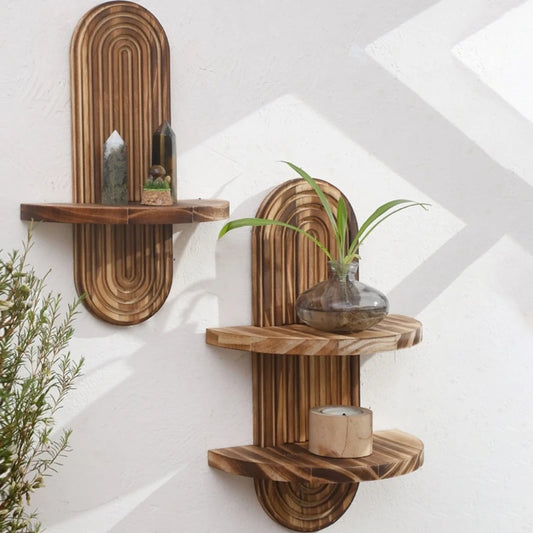Two Nutshell wooden wall shelf units in natural wood finish mounted on white wall with plant decor