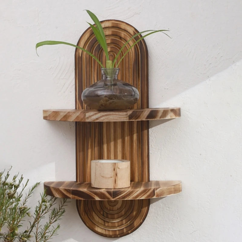 Nutshell wooden wall shelf two tier arched design in natural wood tones with vase and candle decor
