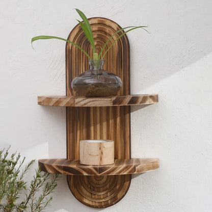 Nutshell wooden wall shelf two tier arched design in natural wood tones with vase and candle decor