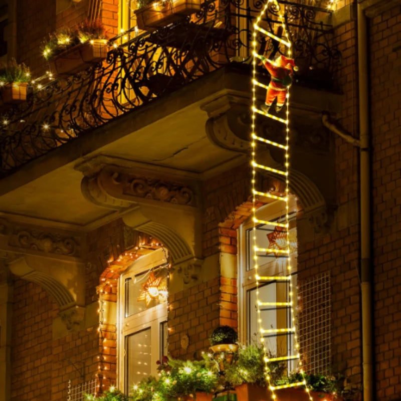Santa climbing ladder Christmas decoration with festive lights on a balcony during the holiday season
