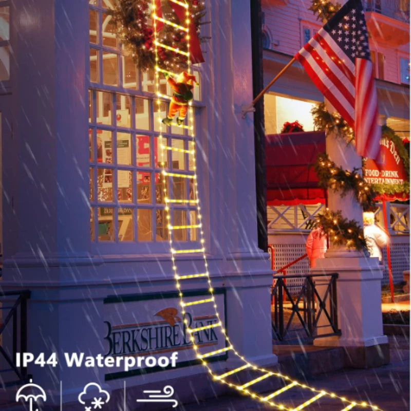 Santa climbing ladder Christmas decoration with festive lights on a storefront during a rainy day