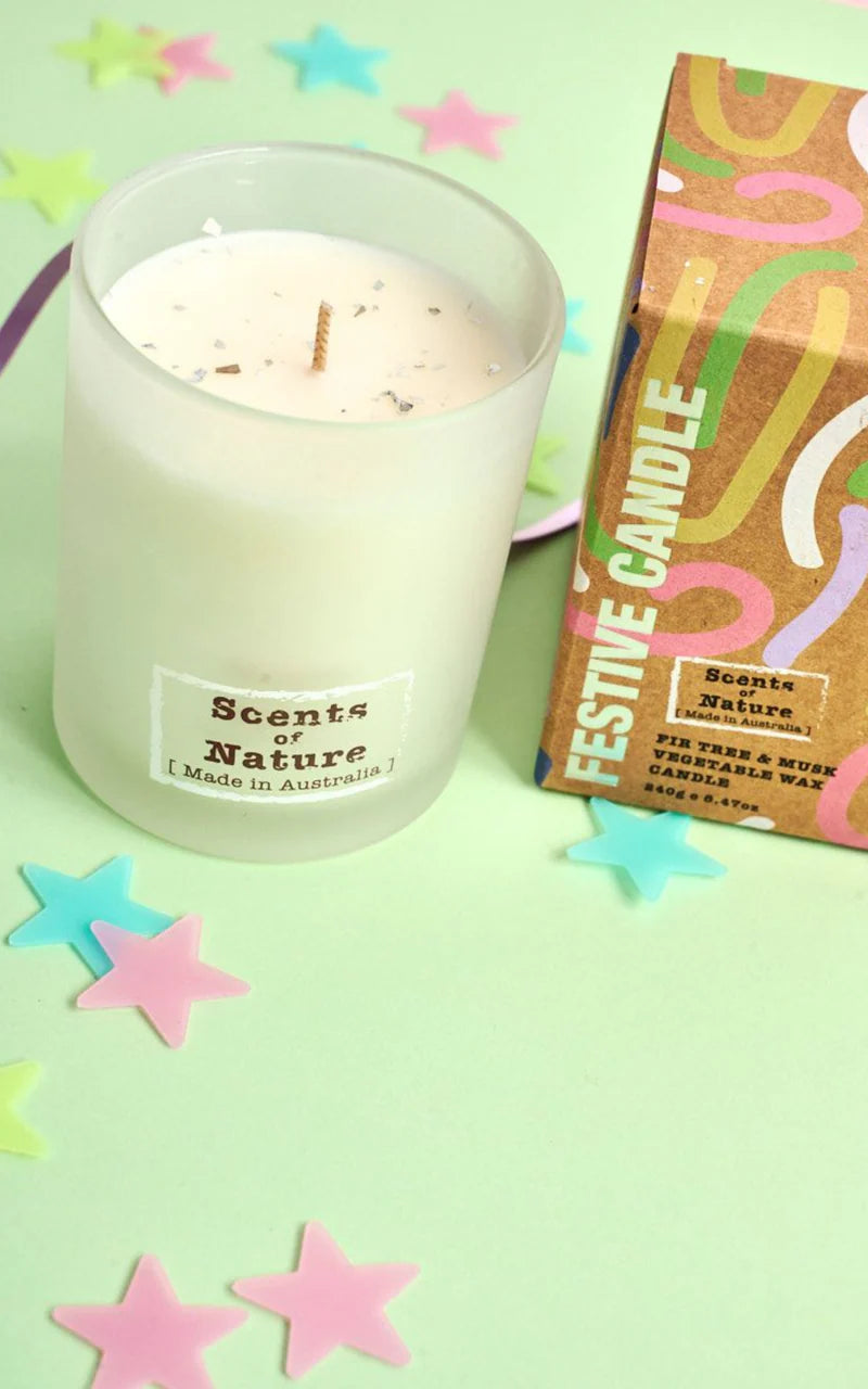 Nutshell Fir Tree and Musk Festive Candle in frosted glass with colorful packaging and star-shaped decorations