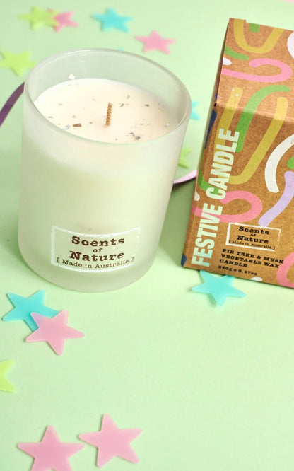Nutshell Fir Tree and Musk Festive Candle in frosted glass with colorful packaging and star-shaped decorations