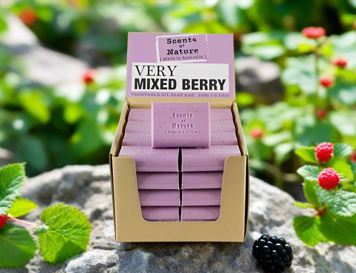 Nutshell Very Mixed Berry soap bars in a cardboard display with berries on a garden stone background Tilley Soap Bars .