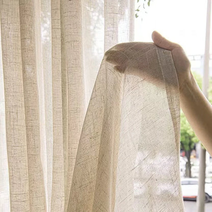 Nutshell Cotton Linen Beige Sheer Curtains held by hand showing lightweight woven texture and light filtering