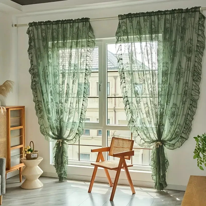 Nutshell Ruffled Floral Sheer Curtain in sage green tied back over large window in sunlit living room