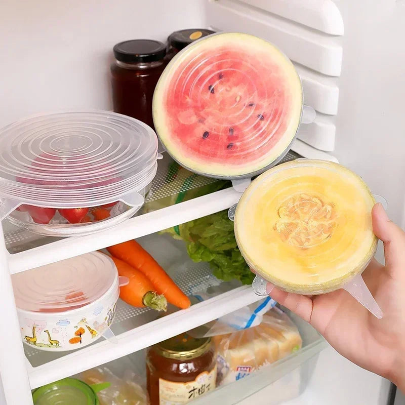 Silicone Stretch Lid set in use on fruits inside a refrigerator for food storage and preservation