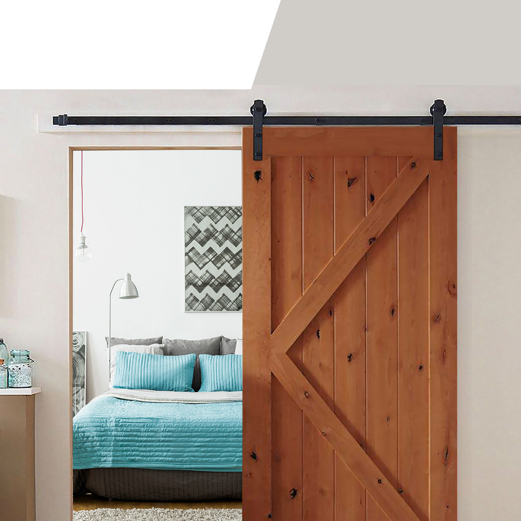 Nutshell sliding barn door hardware installed with wooden barn door in a modern bedroom interior