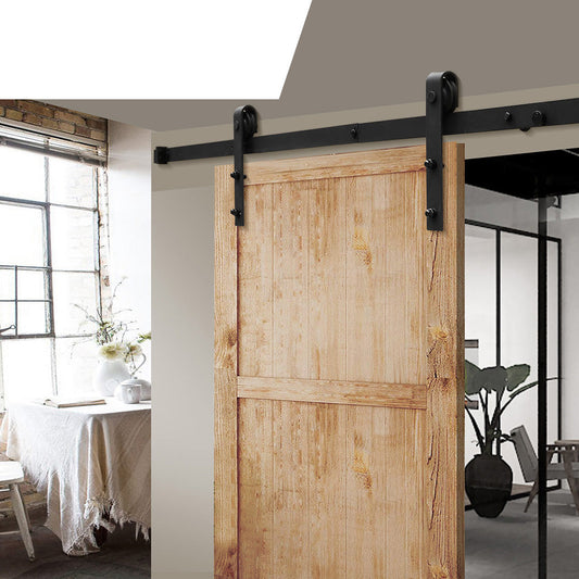 Nutshell sliding barn door hardware installed on a wooden barn door in a modern home interior