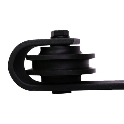 Nutshell black metal sliding barn door hardware close-up showing wheel and bracket detail