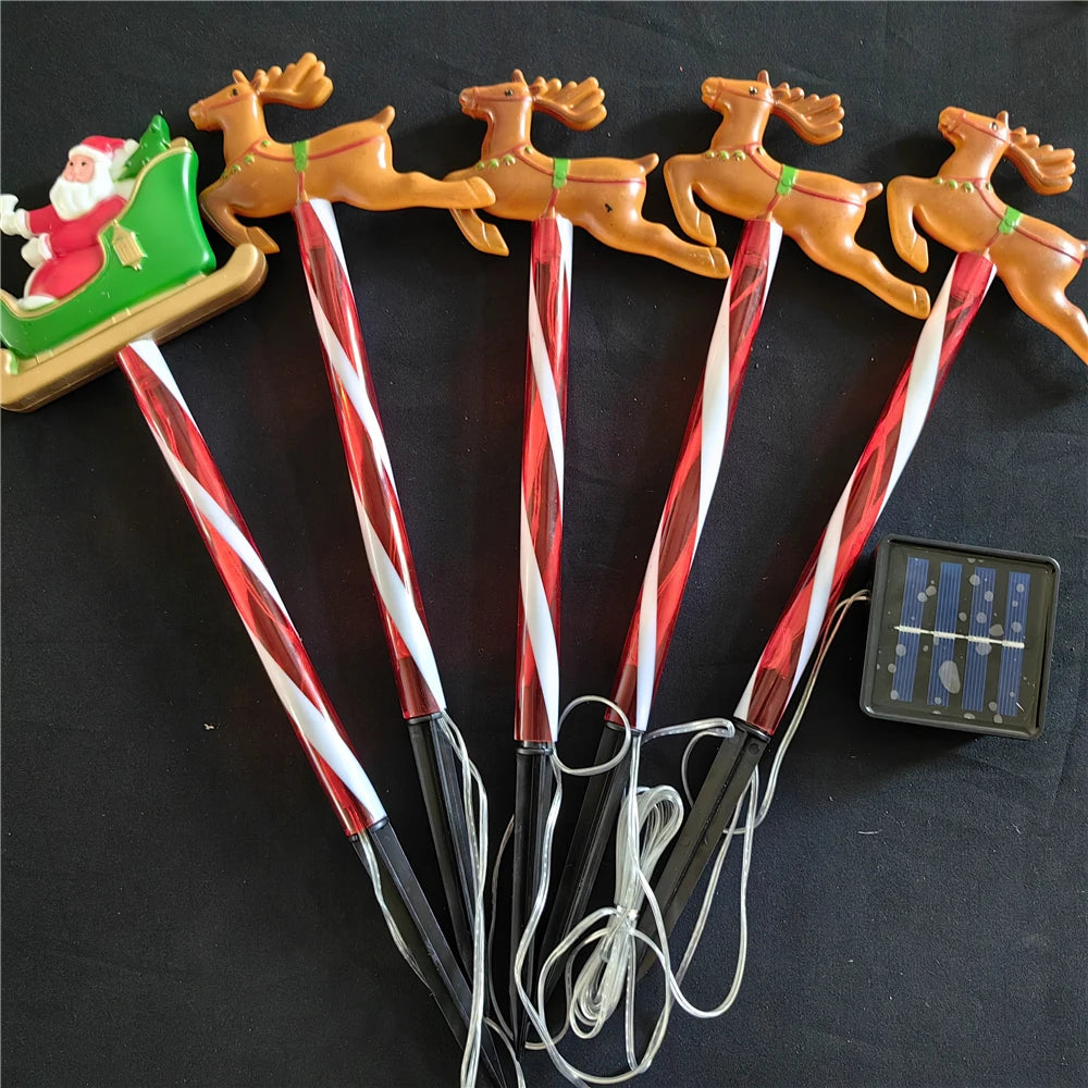 Nutshell solar Christmas pathway lights featuring Santa on a sleigh with reindeer for festive holiday decor