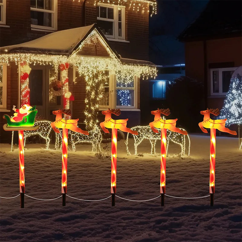 Decorative solar Christmas pathway lights featuring Santa in a sleigh and reindeer for festive outdoor displays