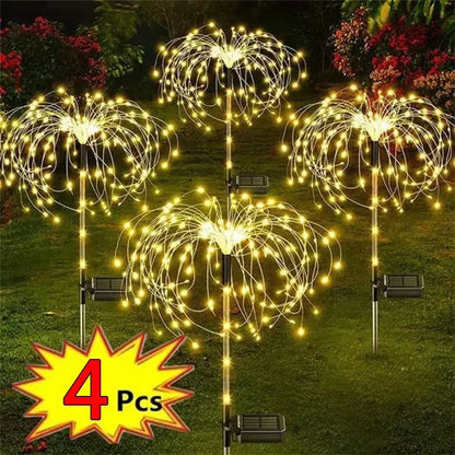 4 Pcs solar firework garden lights glowing brightly in a garden setting for festive illumination
