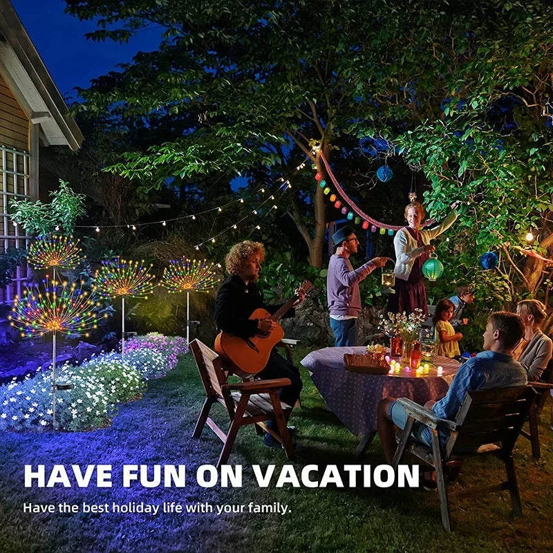 Solar firework garden lights illuminating a festive outdoor gathering with family and friends