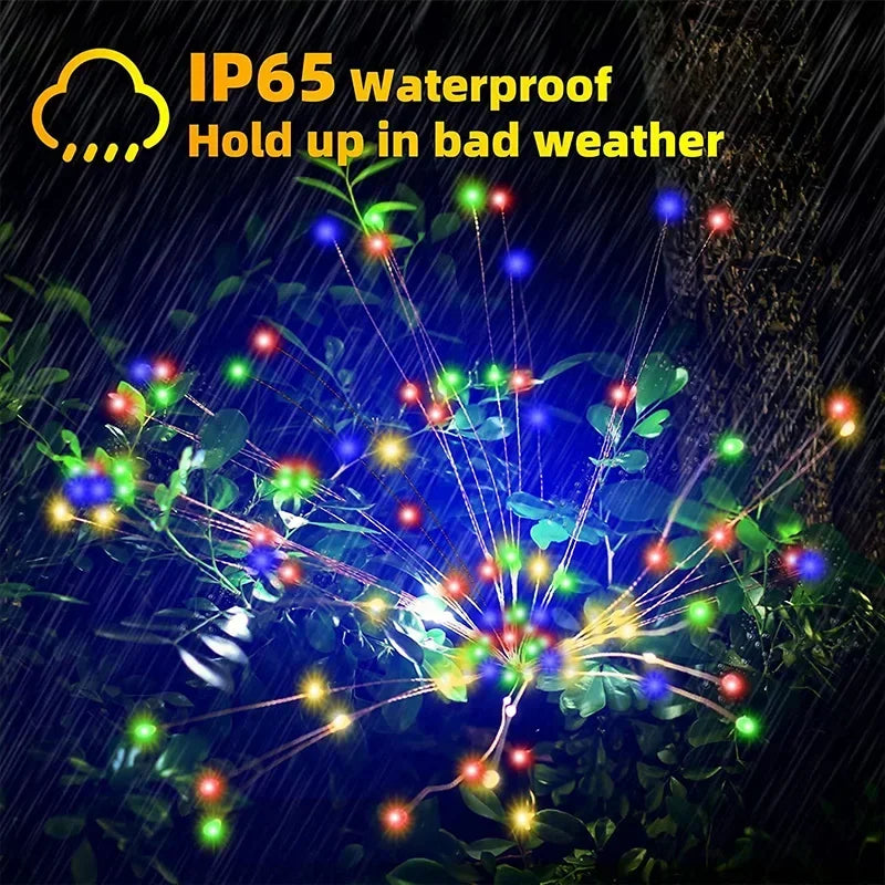 Colorful solar firework garden lights illuminating a rain-soaked garden with IP65 waterproof feature