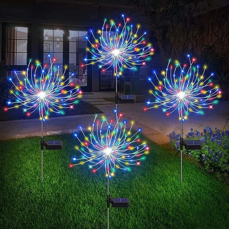 Colorful solar firework garden lights illuminating the lawn at night with vibrant LED bulbs