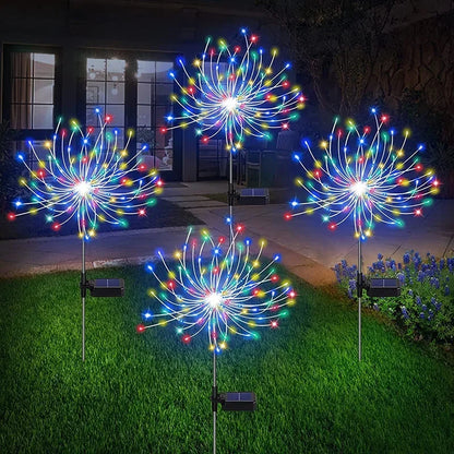 Colorful solar firework garden lights illuminating the lawn at night with vibrant LED bulbs